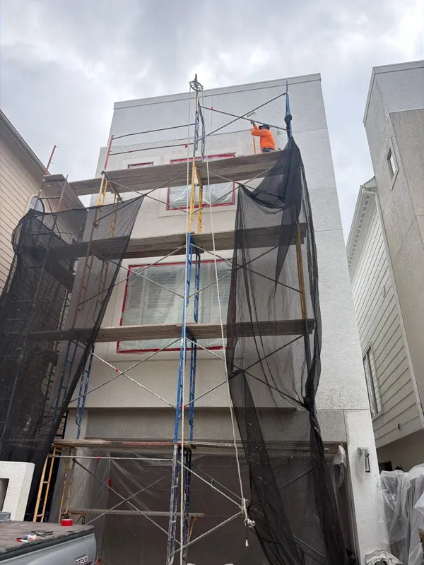 Tall townhouse facade behind scaffolding