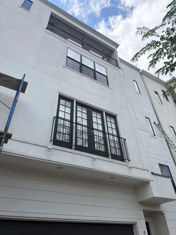 White townhome facade with black window trim