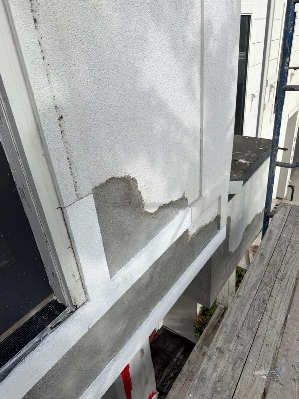 Opened exterior finish beneath a window