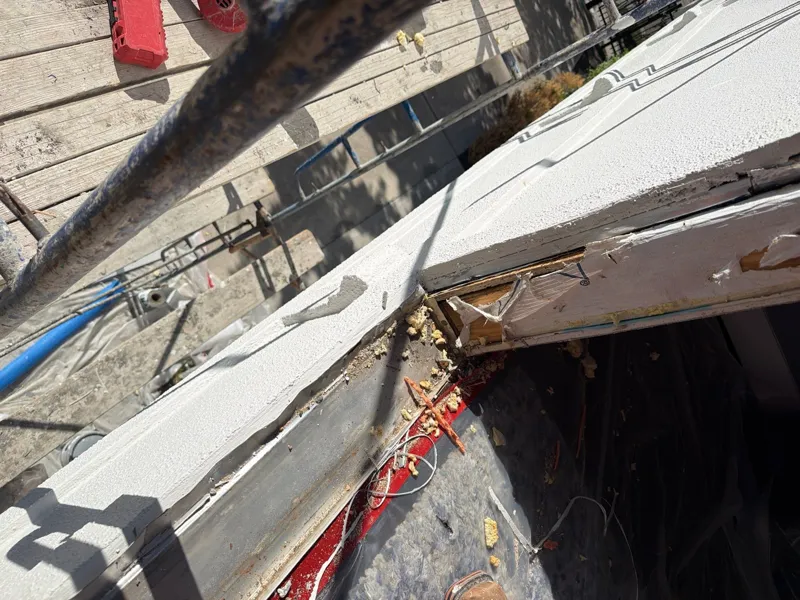 Opened stucco and exterior layers below a window