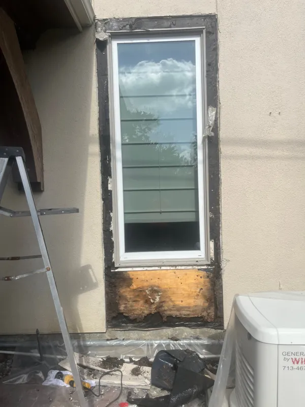 Exposed wood beneath a residential window