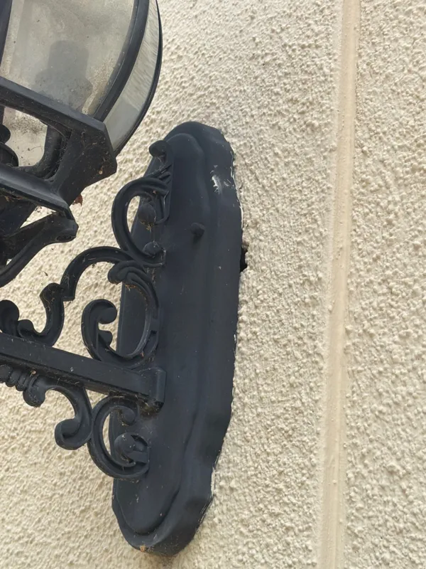 Textured stucco beside an exterior lantern