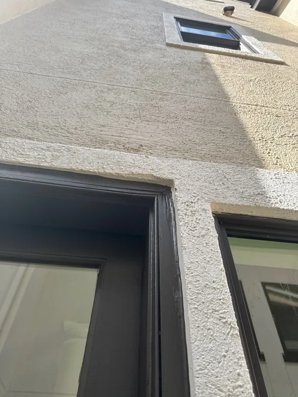 Stucco wall and windows seen from below