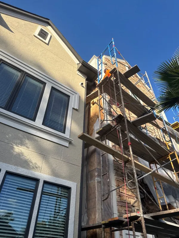Scaffolding beside a residential window wall