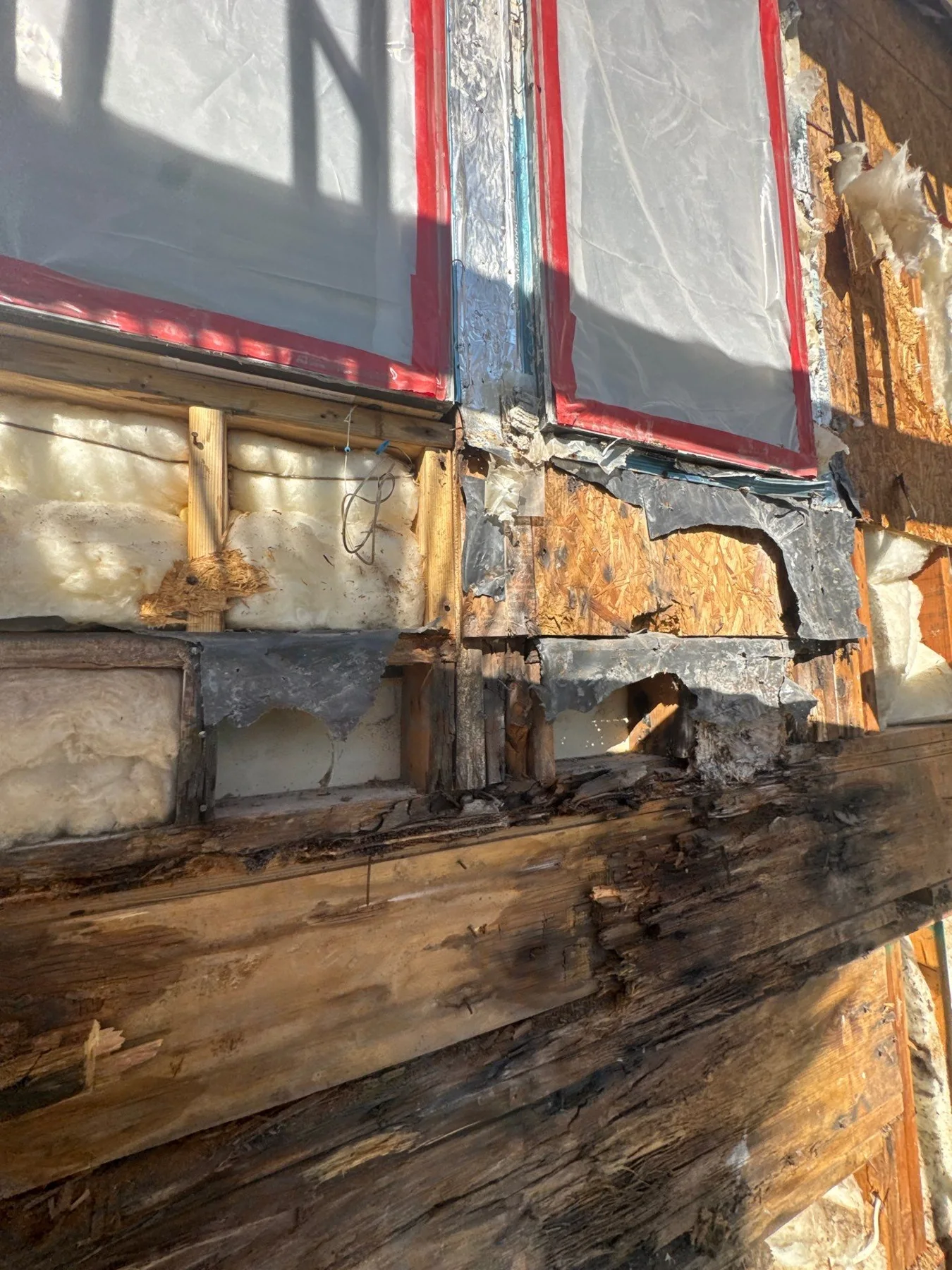 Wood sheathing around a protected exterior window
