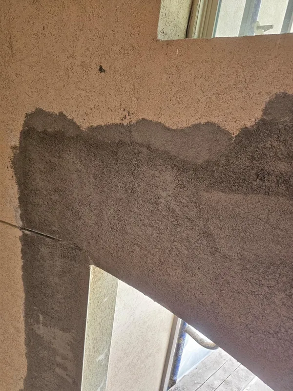 Stucco coating applied across an exterior wall section