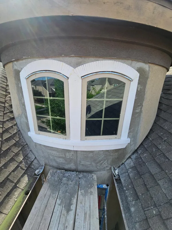 Stucco base coat around the curved window surround