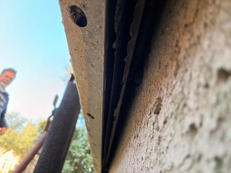 Close view of a stucco edge and underlying material