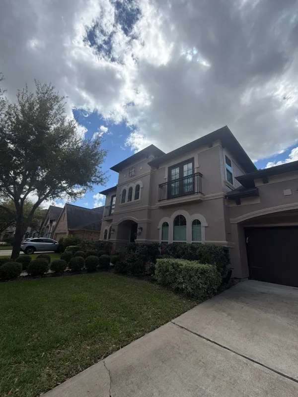 Stucco home and front landscaping in a later project photograph