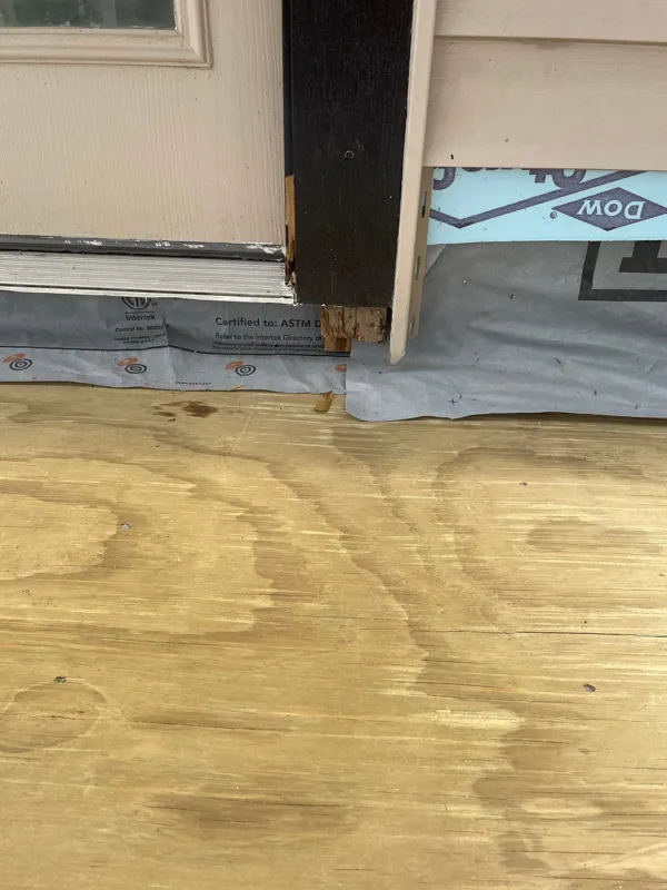 Exposed wood deck surface beside an exterior door