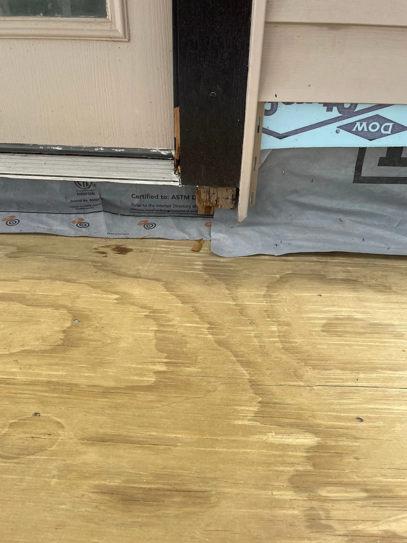 Exposed wood deck surface beside an exterior door