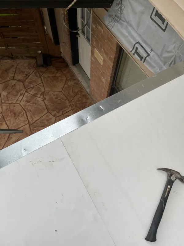 Waterproofing and sheathing beside an upper deck opening
