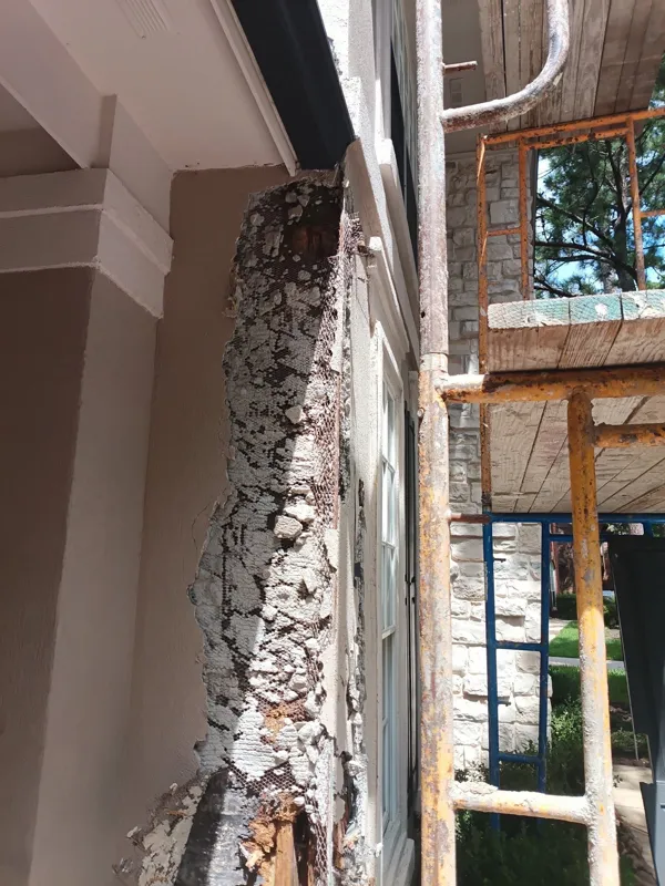 Exposed exterior wall beside a tall window