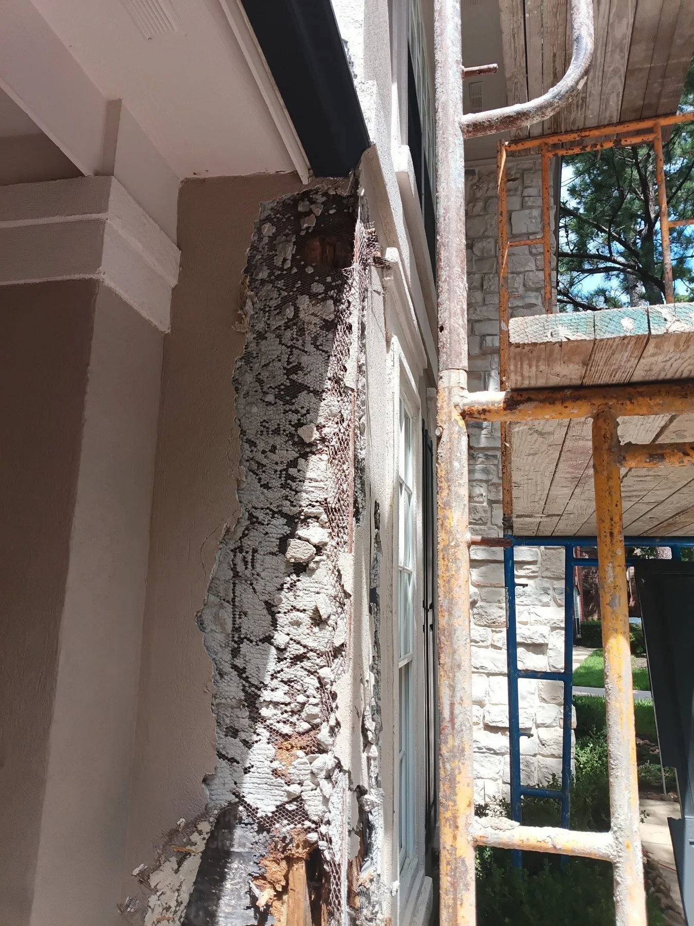 Exposed exterior wall beside a tall window