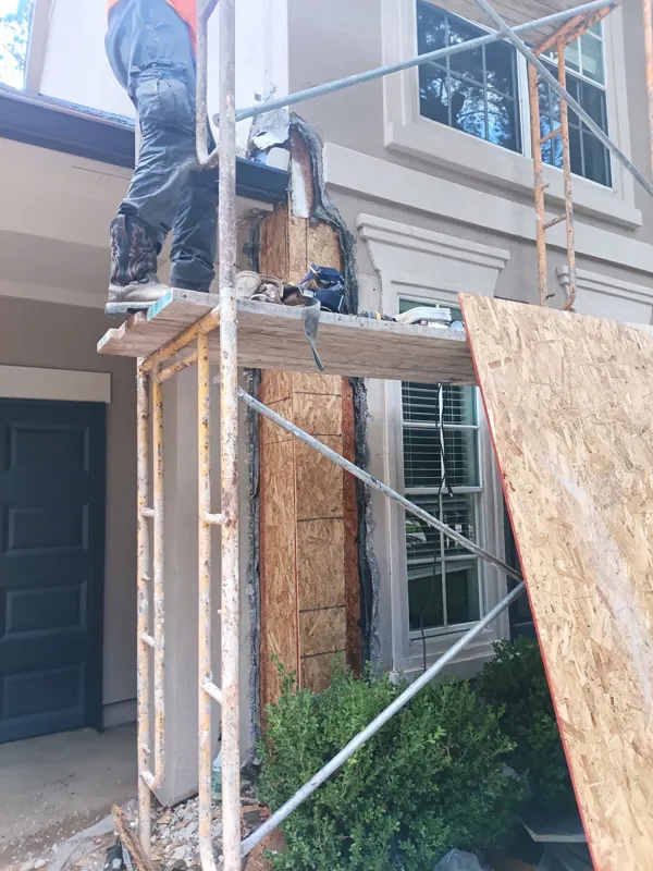 Scaffolding beside a residential window and exterior wall