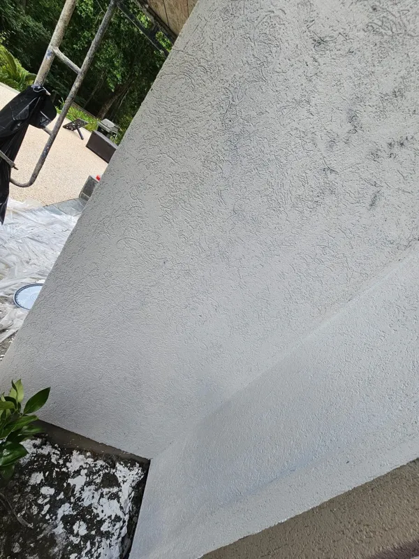 Light-colored stucco surface in a later project photo