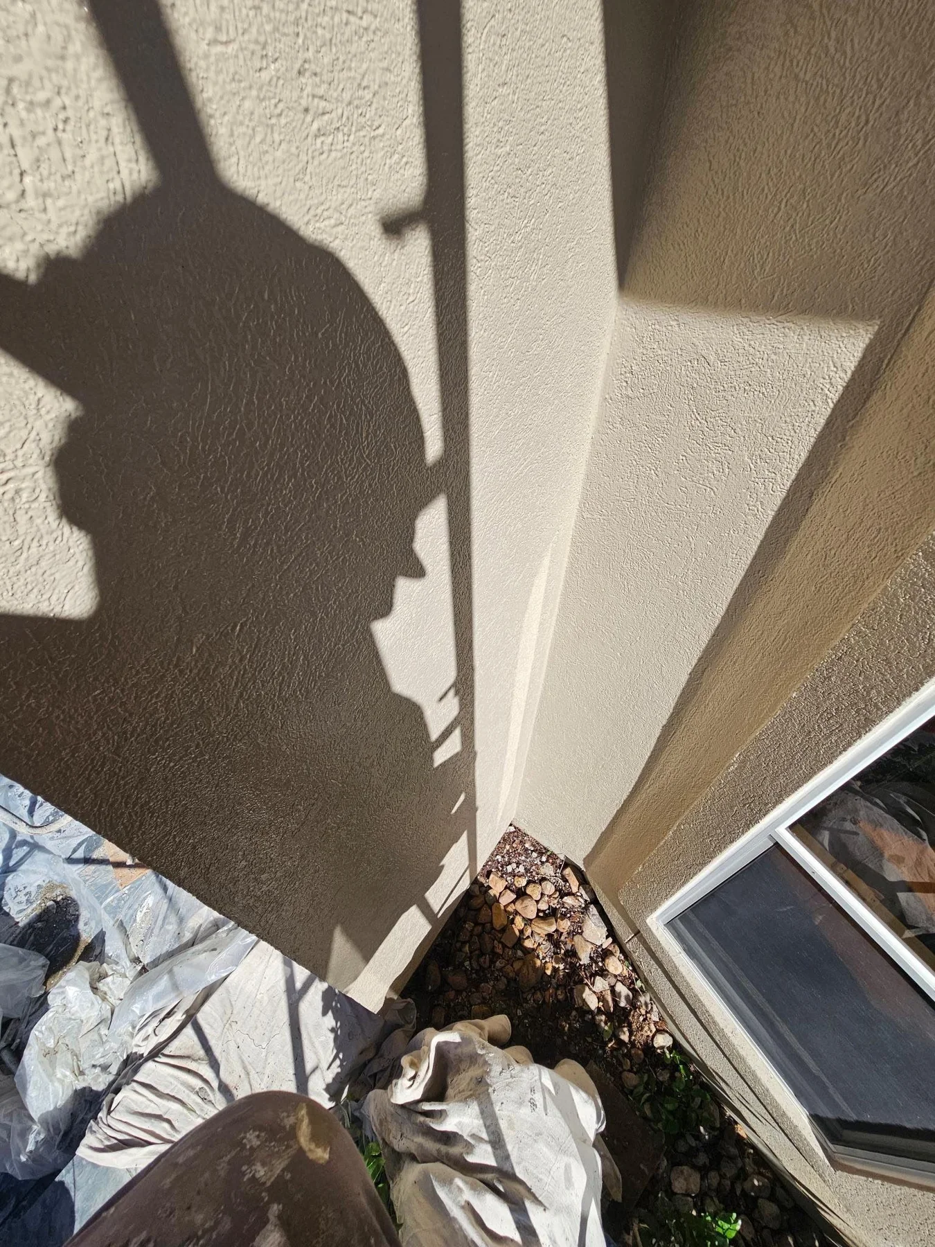 Stucco wall and trim at the roofline in a later view