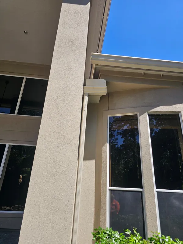 Tall window and adjoining stucco wall