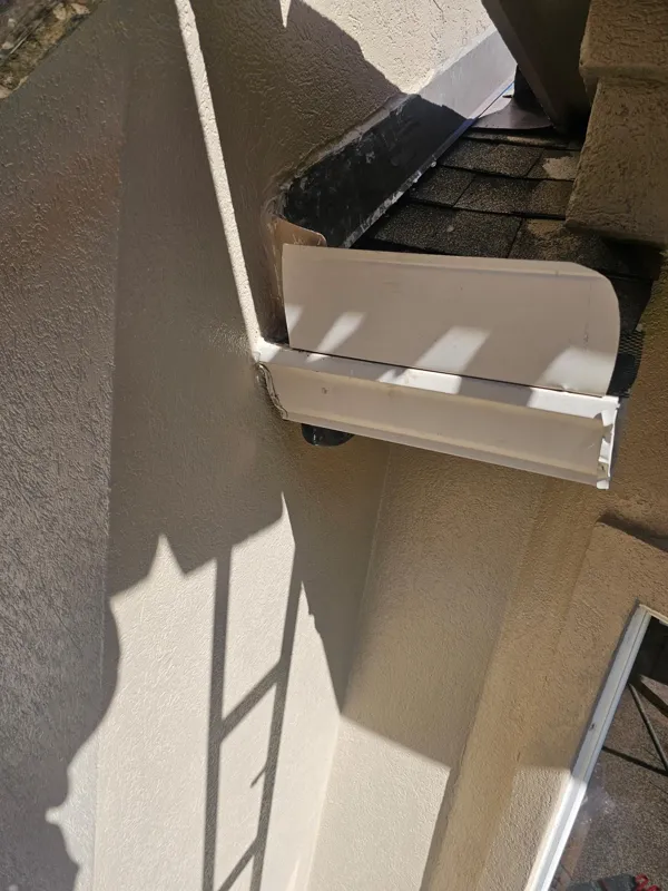 Exterior trim and stucco beneath the roof overhang