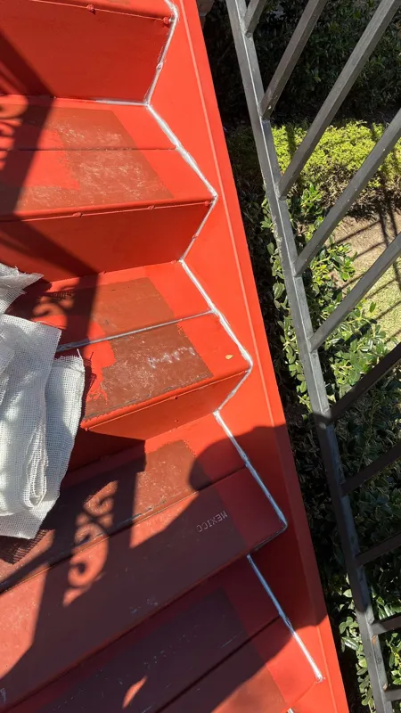Red waterproofing coating on outdoor stair treads